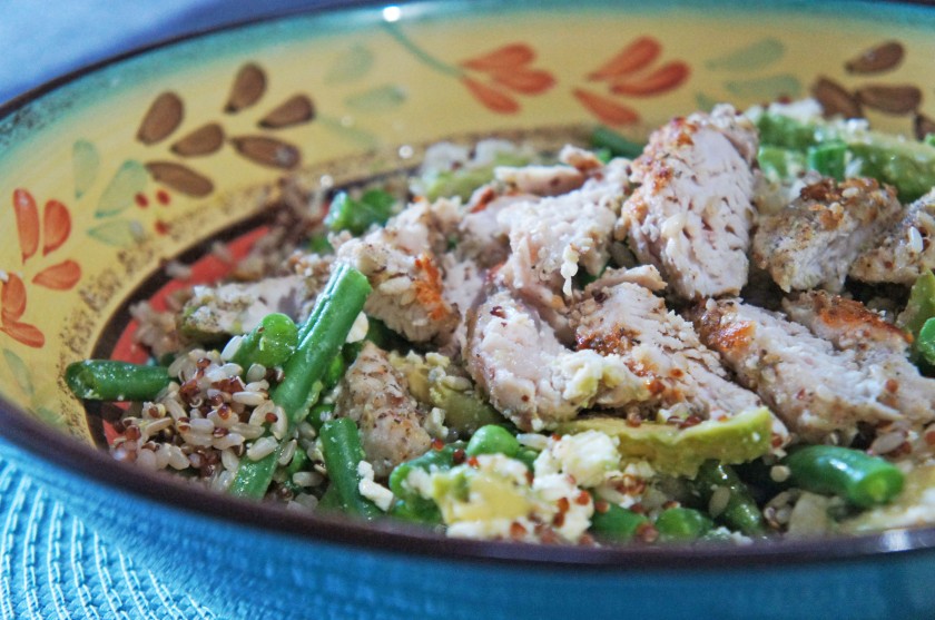 A quinoa salad with spring greens, chicken and seeds